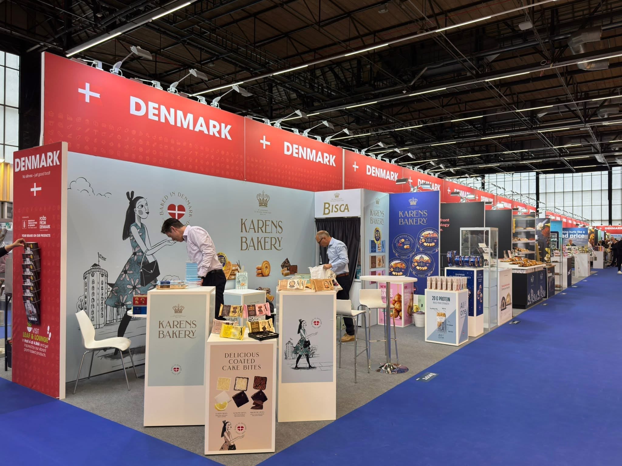 Large trade show exhibition hall with professional booth lighting setup