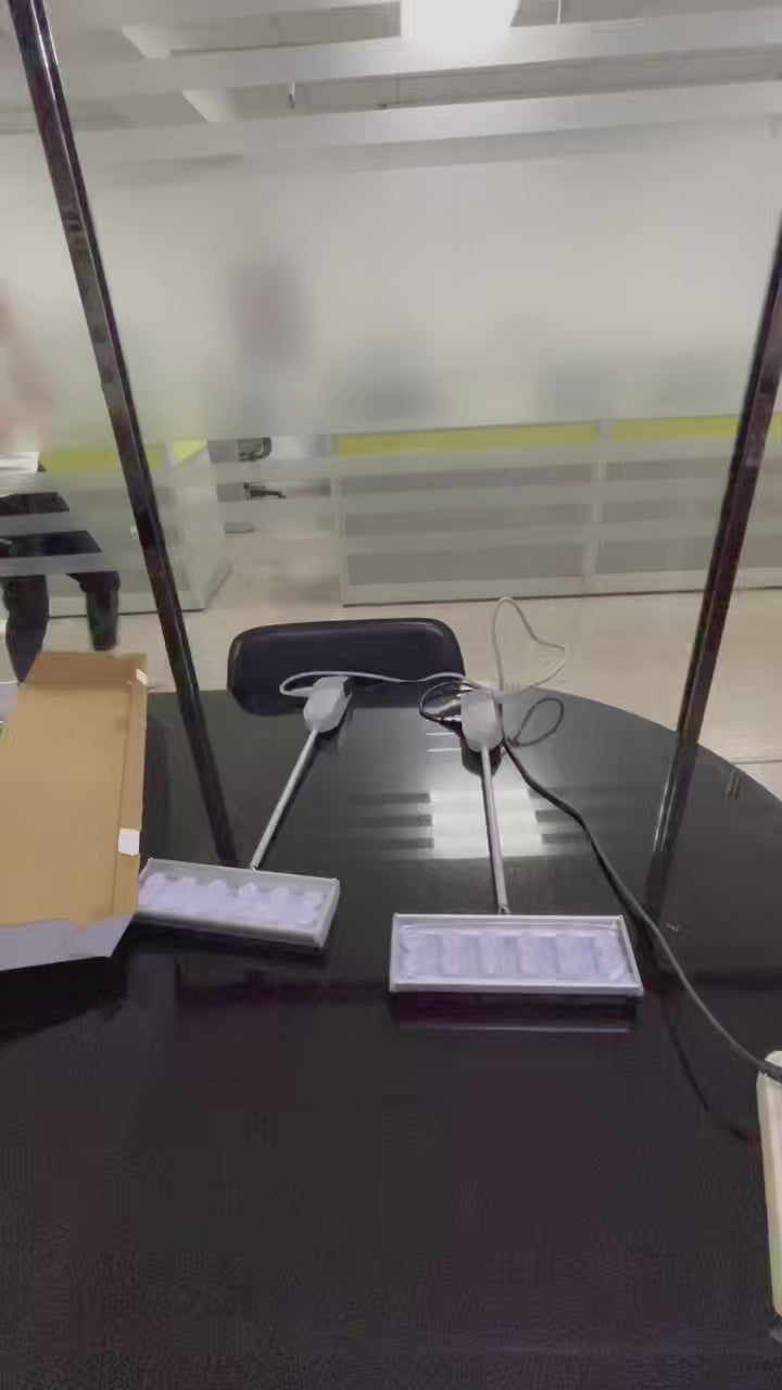 Original tabletop recording of two 35W LED exhibition arm lights before and after switch-on.