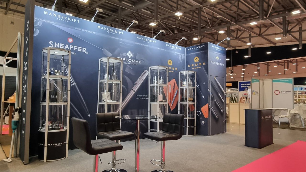 25W Tri-CCT LED arm lights above a display wall and glass product showcases